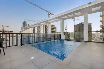 a swimming pool on the roof of a building at Brand New Luxury 2 Bedroom in Dubai