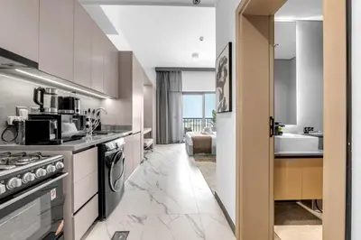 a kitchen with a stove and a sink at New Studio in Meydan I MAG 890 in Dubai