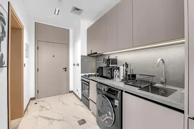 a kitchen with a washer and dryer in at New Studio in Meydan I MAG 890 in Dubai