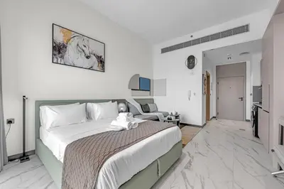 a bedroom with a large bed with a teddy bear on it at New Studio in Meydan I MAG 890 in Dubai