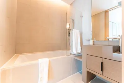 a bathroom with a bath tub and a sink at Luxury 1BR Sea View Apt Address JBR Dubai in Dubai
