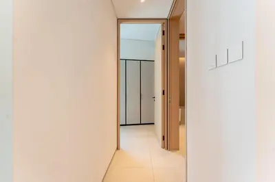 a hallway with white walls and a glass door at Luxury 1BR Sea View Apt Address JBR Dubai in Dubai