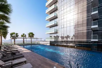 an exterior view of a hotel with a swimming pool at Carson A - High Rise Cosy Studio with City Views in Dubai