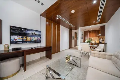 a living room with a couch and a tv at Modern Studio in the Heart of Sports City in Dubai
