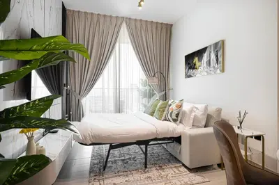 a living room with a couch and a window at Luxury Stay in JVC in Dubai