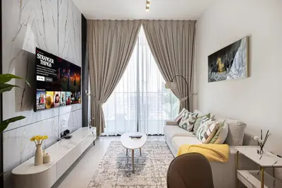 a living room with a couch and a table at Luxury Stay in JVC in Dubai