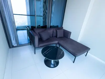 a living room with a couch and a table at Modern 2BR Apartment with Stunning City Views in Dubai