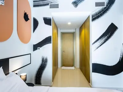 a bedroom with a bed and a large poster on the wall at Modern 2BR Apartment with Stunning City Views in Dubai