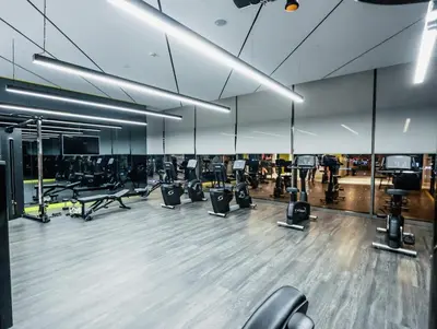 a gym with rows of exercise equipment in a room at Modern 2BR Apartment with Stunning City Views in Dubai