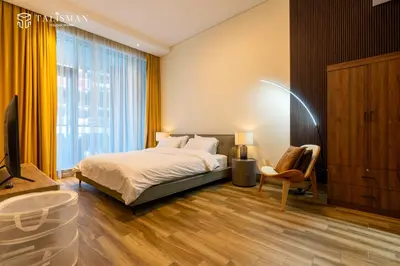 a bedroom with a bed and a large window at Elegant 1 BR Apartment in J One Tower in Dubai