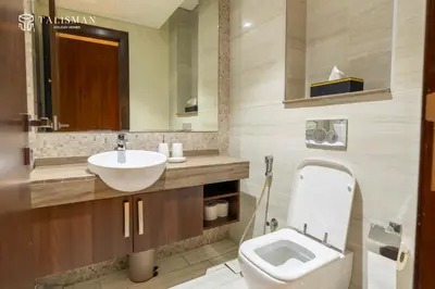 a bathroom with a white toilet and a sink at Elegant 1 BR Apartment in J One Tower in Dubai