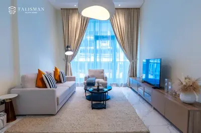 a living room with a couch and a tv at Elegant 1 BR Apartment in J One Tower in Dubai