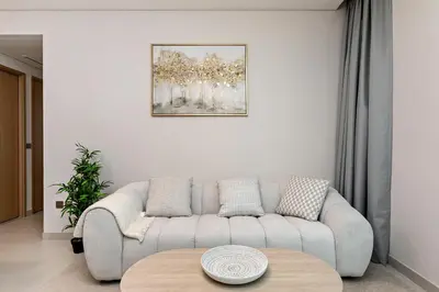 a living room with a couch and a table at Vida Dubai Mall Connected 2BR in Sabkhah