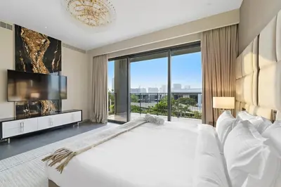 a bedroom with a large white bed and a large window at FIRST CLASS Villa Private Pool & Garden Bliss in Dubai