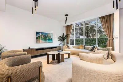 a living room with a couch and chairs and a table at FIRST CLASS VILLA Tranquility Meets Luxury in Dubai