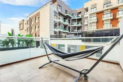 a hammock on the balcony of a building at FIRST CLASS VILLA Tranquility Meets Luxury in Dubai