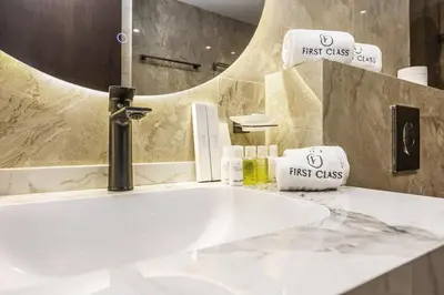 a bathroom with a white sink and a mirror at FIRST CLASS VILLA Tranquility Meets Luxury in Dubai