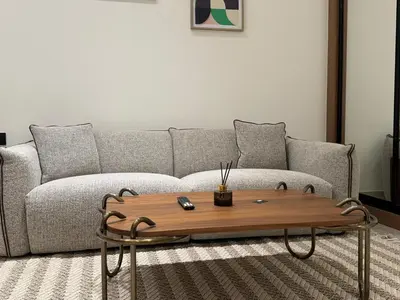 a living room with a couch and a coffee table at DVR Studio Apartment with private jaccuzi in Trillionaire by Binghatti Business Bay in Dubai