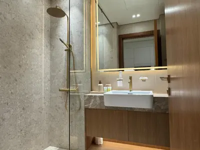 a bathroom with a sink and a shower at DVR Studio Apartment with private jaccuzi in Trillionaire by Binghatti Business Bay in Dubai