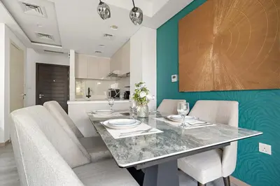a dining room with a table and chairs at FIRST CLASS VILLA Spacious for Family Getaways in Dubai