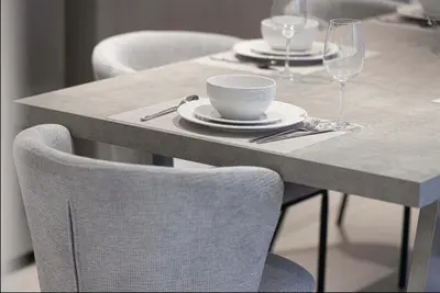a table with plates and a bowl and a cup and a glass at Restay Homes at Act Towers by Emaar - Pool access with Burj View included - Luxury Apartments in Downtown in Dubai