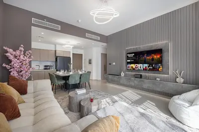 a living room with a couch and a dining room at Restay Homes at Act Towers by Emaar - Pool access with Burj View included - Luxury Apartments in Downtown in Dubai