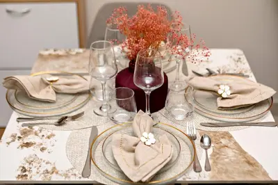 a table with plates and napkins and wine glasses at Vida Dubai Mall Connected 1BR in Dubai