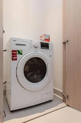 a white washing machine sitting in a room at Vida Dubai Mall Connected 1BR in Dubai