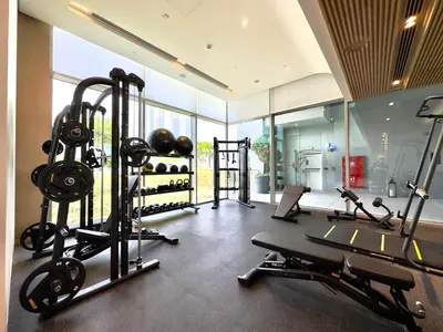 a gym with several treadmills and weights in a room at Vida Dubai Mall Connected 1BR in Dubai