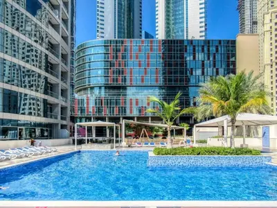 a pool in the middle of a city with tall buildings at Bay View in Marina Bay in Dubai