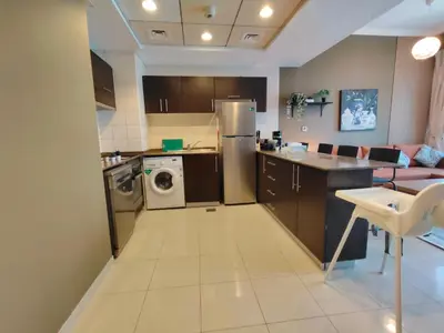 a kitchen with a refrigerator and a washer and dryer at Bay View in Marina Bay in Dubai