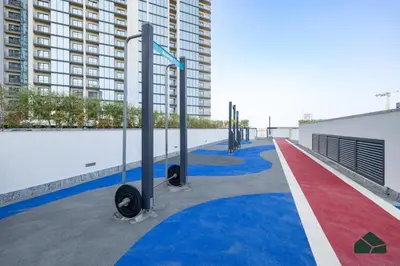 a red white and blue carpeted walkway in front of a building at Stylish 1BR with City and Partial Burj View by BMS in Dubai