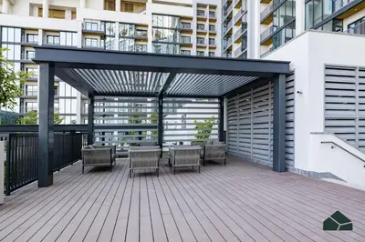 a deck with chairs and a table on a building at Stylish 1BR with City and Partial Burj View by BMS in Dubai