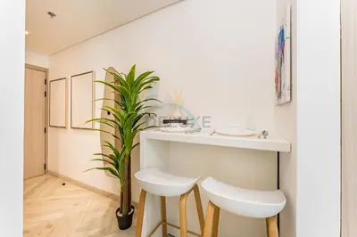 a bathroom with a white counter and a plant at Studio with Community Views, Easy Access to Bus Stop, Parks, and Circle Mall, Empire Residence, JVC by Deluxe Holiday Homes in Dubai