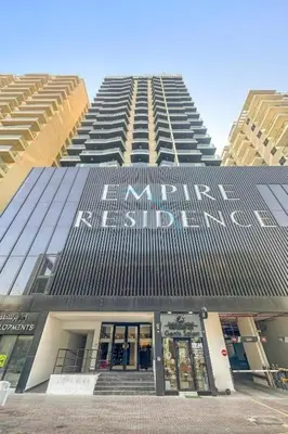 a tall building with a sign on the side of it at Studio with Community Views, Easy Access to Bus Stop, Parks, and Circle Mall, Empire Residence, JVC by Deluxe Holiday Homes in Dubai