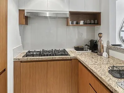 a kitchen with a stove and a counter top at Waterfront Breathtaking 2BR Pool Burj Views Sleeps 7 in Dubai