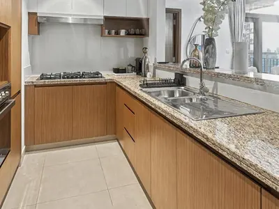 a kitchen with a sink and a counter top at Waterfront Breathtaking 2BR Pool Burj Views Sleeps 7 in Dubai