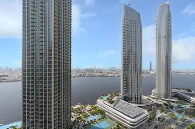 two tall buildings in a city with a body of water at Waterfront Breathtaking 2BR Pool Burj Views Sleeps 7 in Dubai