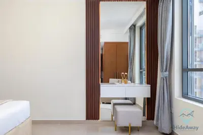 a bathroom with a sink and a mirror at Waterfront Breathtaking 2BR Pool Burj Views Sleeps 7 in Dubai
