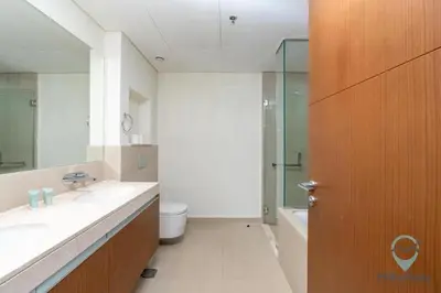 a bathroom with a sink and a toilet and a shower at Waterfront Breathtaking 2BR Pool Burj Views Sleeps 7 in Dubai
