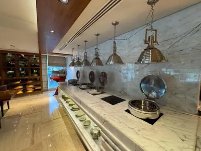 a kitchen with a counter with pots and pans at Damac Maison Canal Views, Luxury Waterfront Apartment, 2 BR, Dedicated Office, Sleeps 6 in Dubai