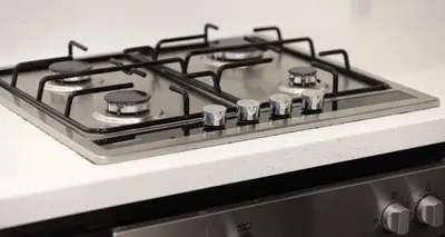 a stove top with four burners on top of it at Damac Maison Canal Views, Luxury Waterfront Apartment, 2 BR, Dedicated Office, Sleeps 6 in Dubai