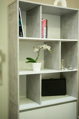 a white book shelf with a plant in it at Damac Maison Canal Views, Luxury Waterfront Apartment, 2 BR, Dedicated Office, Sleeps 6 in Dubai