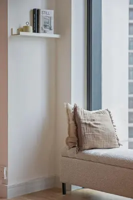 a couch with a pillow on it in a room at Brand new 2BR in Downtown 5 min walk to Burj Khalifa in Dubai