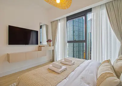 a white bedroom with a large window with a tv at Brand new 2BR in Downtown 5 min walk to Burj Khalifa in Dubai