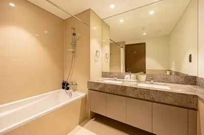 a bathroom with two sinks and a bath tub and a mirror at Brand new 2BR in Downtown 5 min walk to Burj Khalifa in Dubai