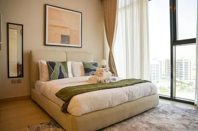 a bedroom with a bed with two teddy bears on it at New Studio in Meydan With Pool & Gym in Dubai
