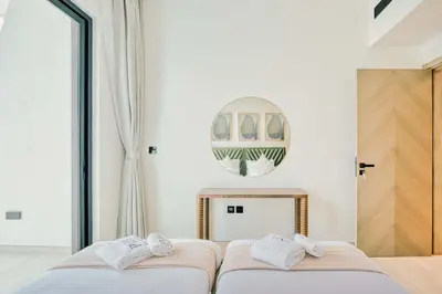 two beds in a bedroom with a fireplace at PVH - Binghatti Heights - Urban Luxury 3BR in Dubai