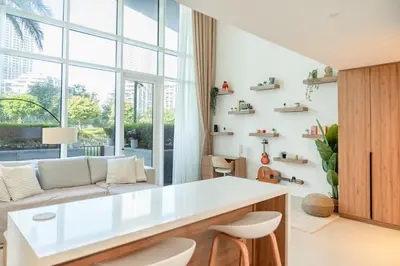 a living room with a white table and a couch at Homely Creek Harbour Apartment - Direct Park Access in Dubai