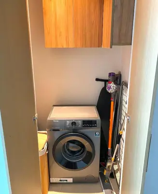 a washer and dryer in a small room at Homely Creek Harbour Apartment - Direct Park Access in Dubai